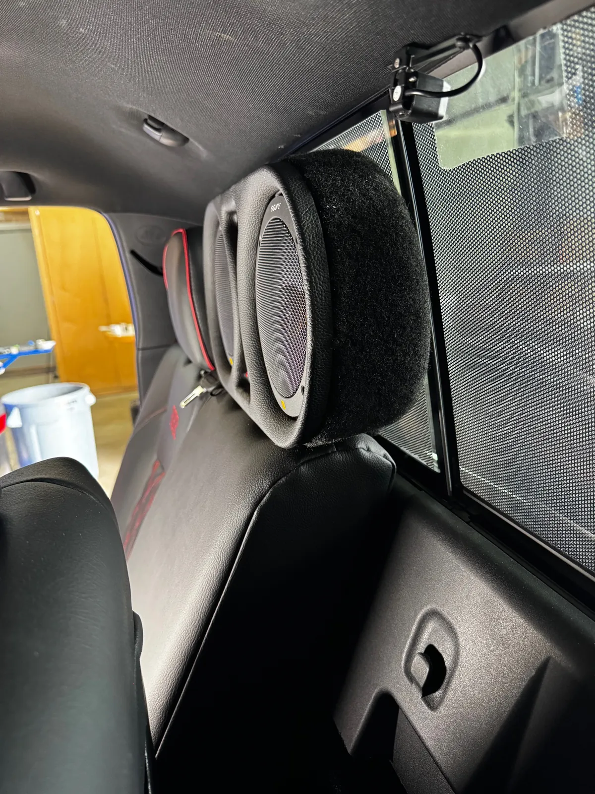 Close-up of a custom upholstered rear-seat speaker pod, 2023 Toyota Tacoma
